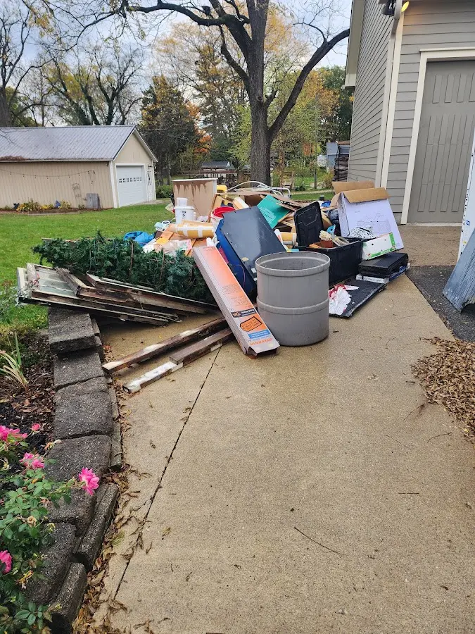 Dumpster being loaded with debris for 12 Yard Dumpster Rental in Caseyville
